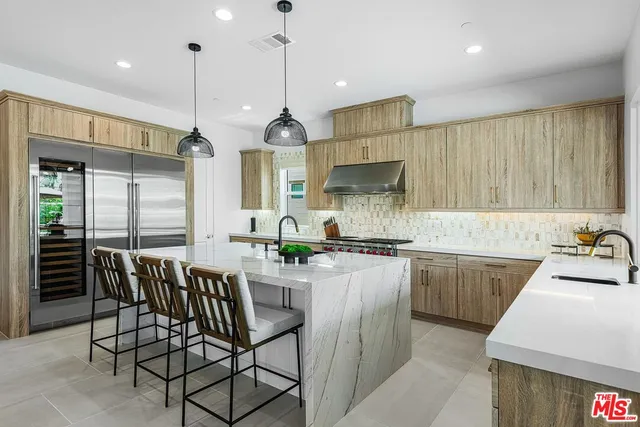 a kitchen with a table chairs stove and cabinets