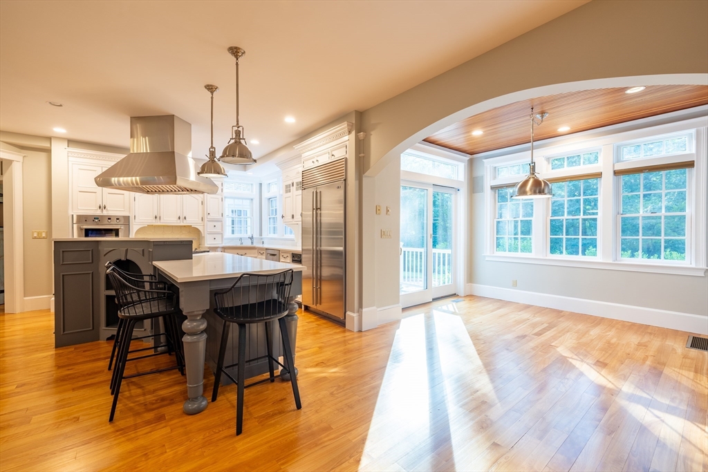 3 W Hollow Andover, MA 01810 - Photo 13 of 37 a dining hall with stainless steel appliances kitchen island granite countertop a table chairs and a large window