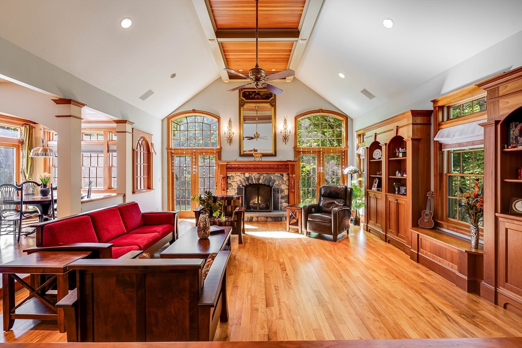 3 W Hollow Andover, MA 01810 - Photo 8 of 37 a living room with furniture a fireplace and a chandelier