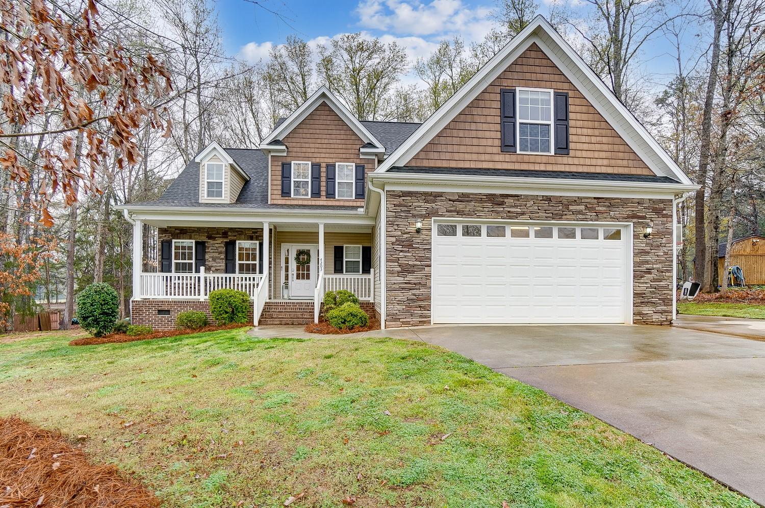 a front view of a house with yard and green space