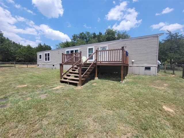 a view of a house with a yard and sitting area