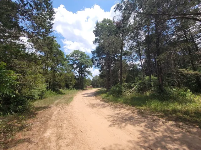 a kitchen with stainless steel appliances granite countertop a refrigerator a sink a stove and a refrigerator with wooden floor