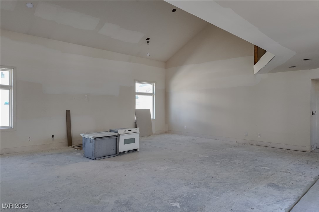 3840 South Topaz Road Las Vegas, NV 89121 - Photo 23 of 89 Spare room featuring concrete floors and high vaulted ceiling