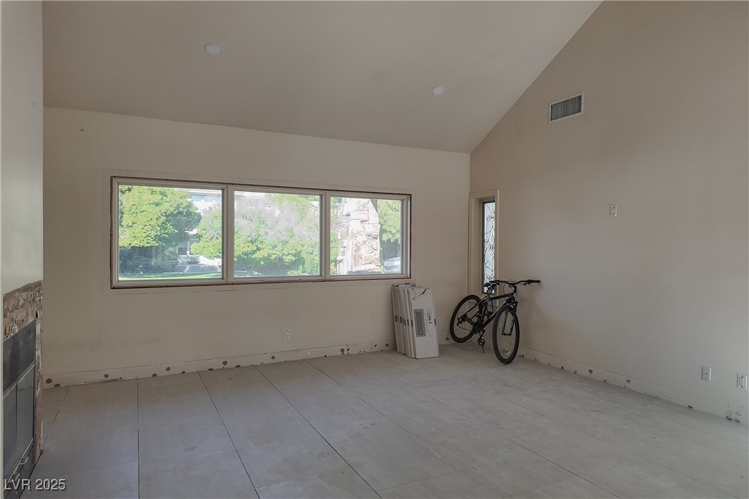 3840 South Topaz Road Las Vegas, NV 89121 - Photo 39 of 89 Spare room with high vaulted ceiling, radiator, and tile patterned flooring
