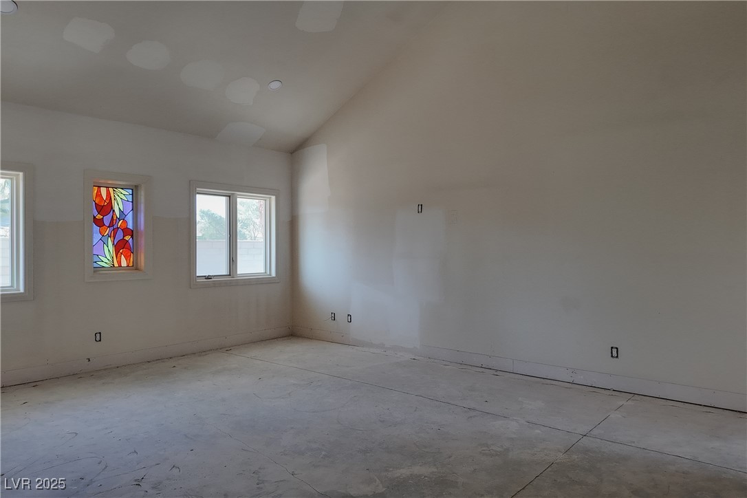 3840 South Topaz Road Las Vegas, NV 89121 - Photo 68 of 89 Empty room featuring concrete flooring and high vaulted ceiling
