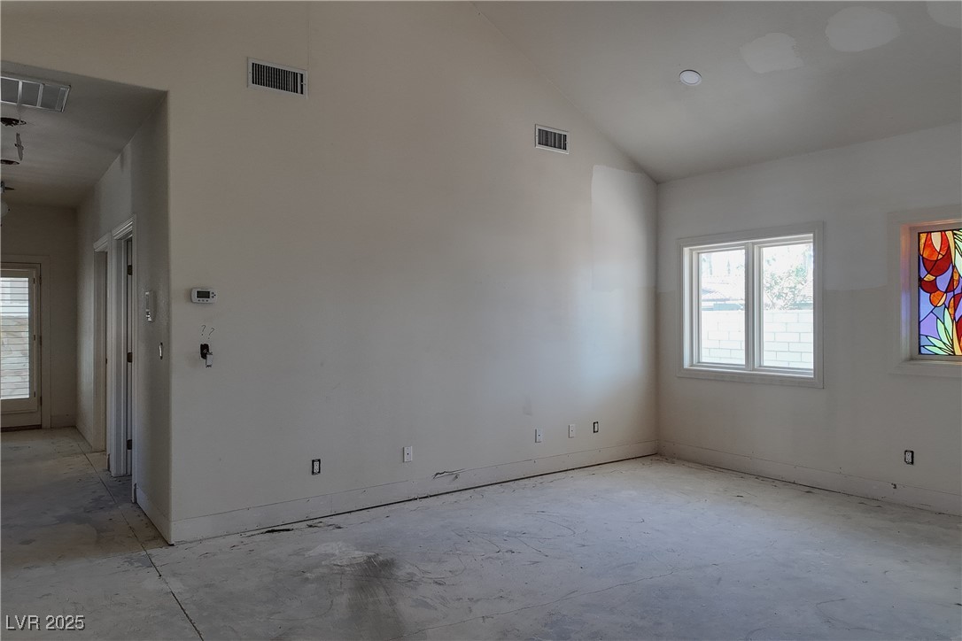 3840 South Topaz Road Las Vegas, NV 89121 - Photo 73 of 89 Empty room featuring plenty of natural light and vaulted ceiling