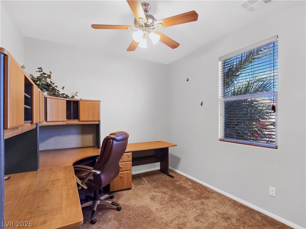 2485 Morrow Ridge Place Laughlin, NV 89029 - Photo 18 of 40 A dedicated home office space with built-in desk and overhead storage for optimal productivity.