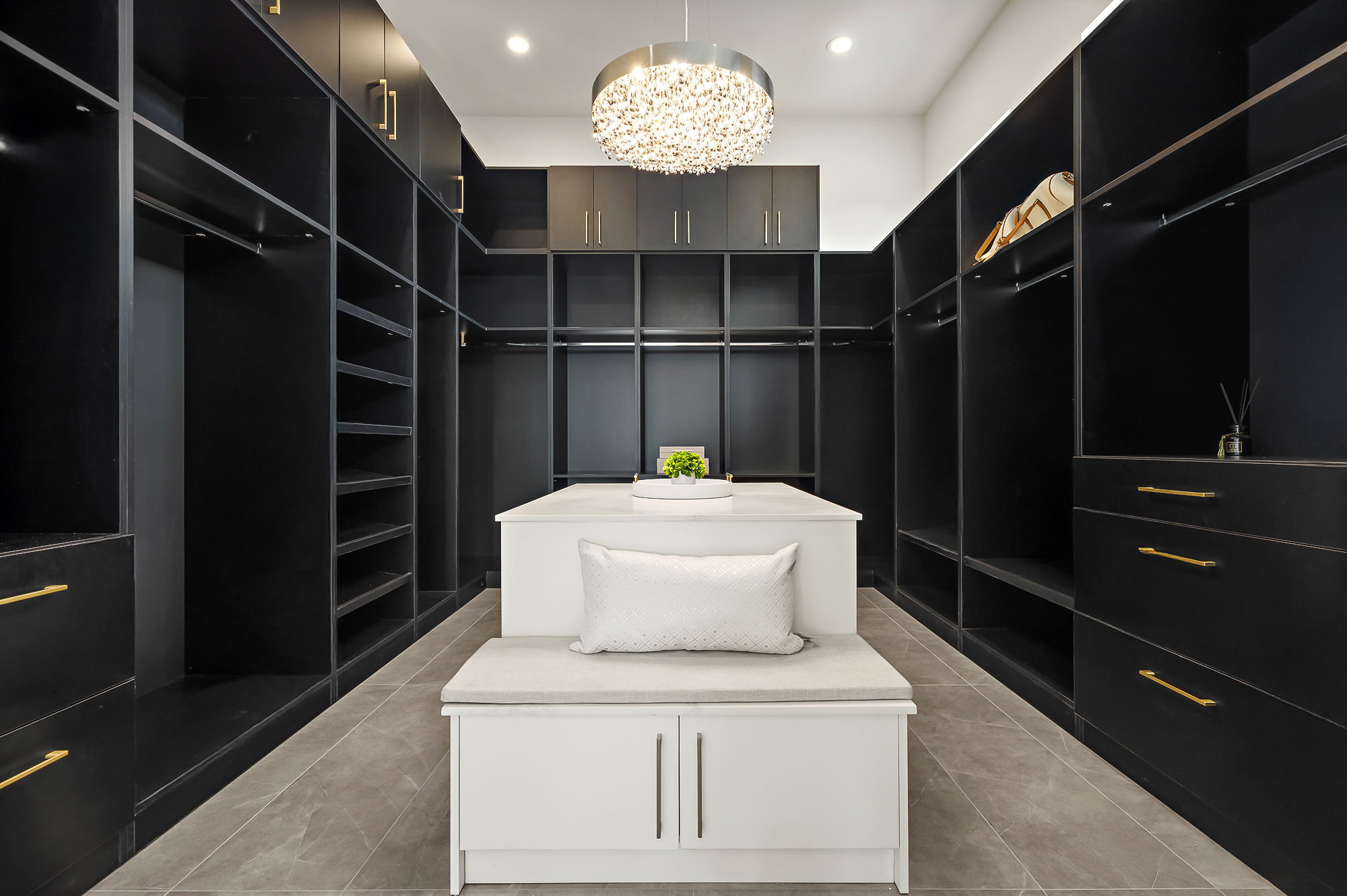 10211 Thistle Ridge Austin, TX 78733 - Photo 20 of 39 Walk in closet with a chandelier and tile patterned floors