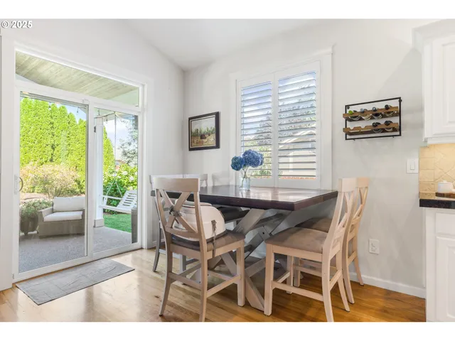 a dining room with furniture and a large window