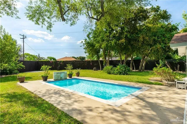 a view of a swimming pool with a yard