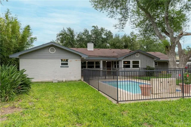 a front view of a house with a garden and deck