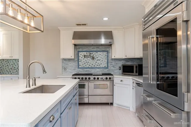 a kitchen with a stove a sink and a microwave