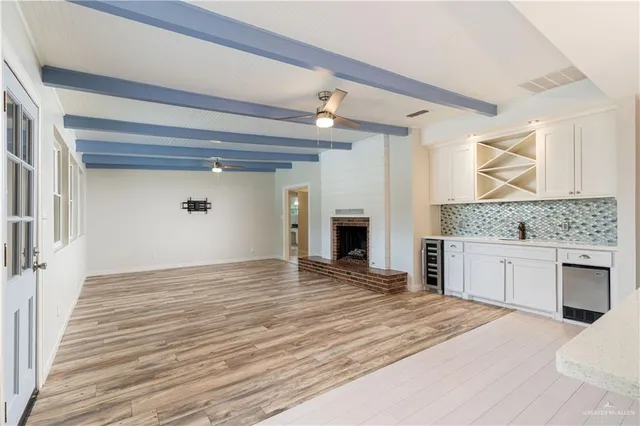 a view of kitchen with granite countertop cabinets and sink
