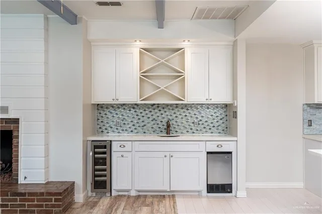 a kitchen with granite countertop a sink cabinets and stainless steel appliances
