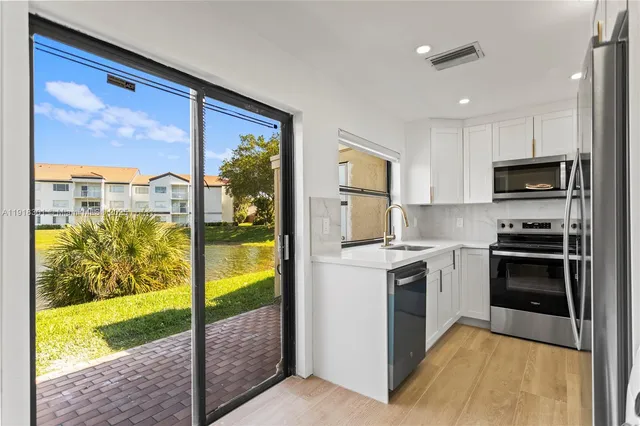 a kitchen with a refrigerator stove and a sink