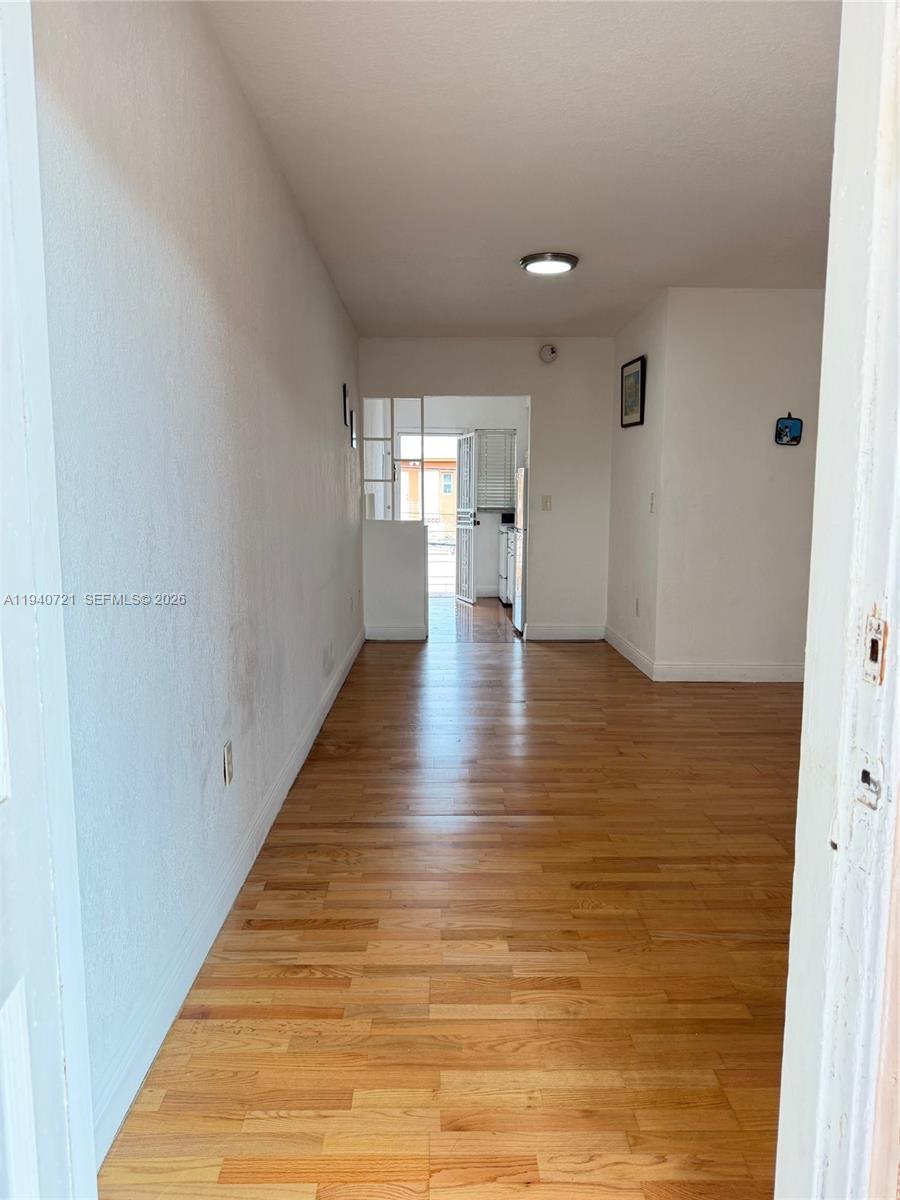 3671 Southwest 10th Street, Unit 9B Miami, FL 33135 - Photo 5 of 15 a view of empty room with wooden floor