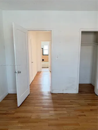 a view of a room with wooden floor