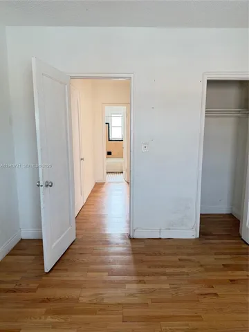 a view of a room with wooden floor