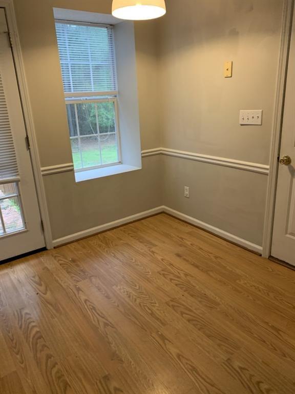 3130 Amber Lane Monroe, GA 30655 - Photo 3 of 11 an empty room with wooden floor and windows