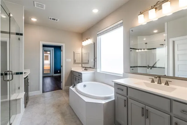 a bathroom with a sink double vanity and a bathtub