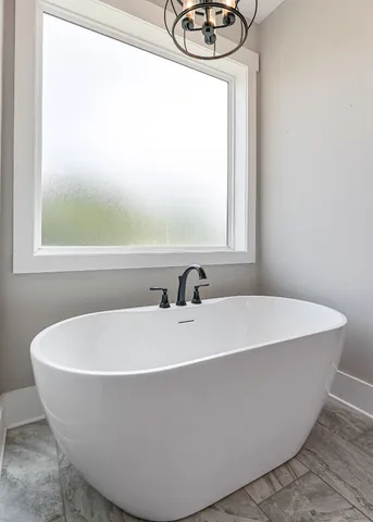 a white bath tub sitting next to a white sink