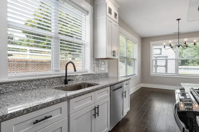 a kitchen with granite countertop a sink and a window