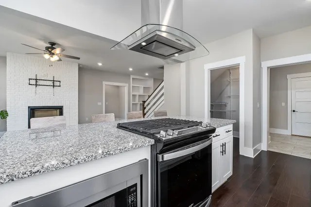 a kitchen with stainless steel appliances granite countertop a stove and a sink