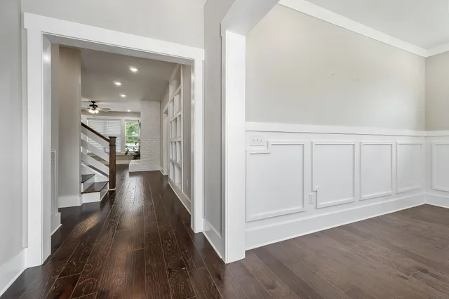 a view of a hallway with wooden floor and closet