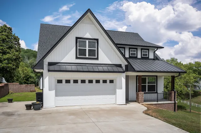 a front view of a house with a garden