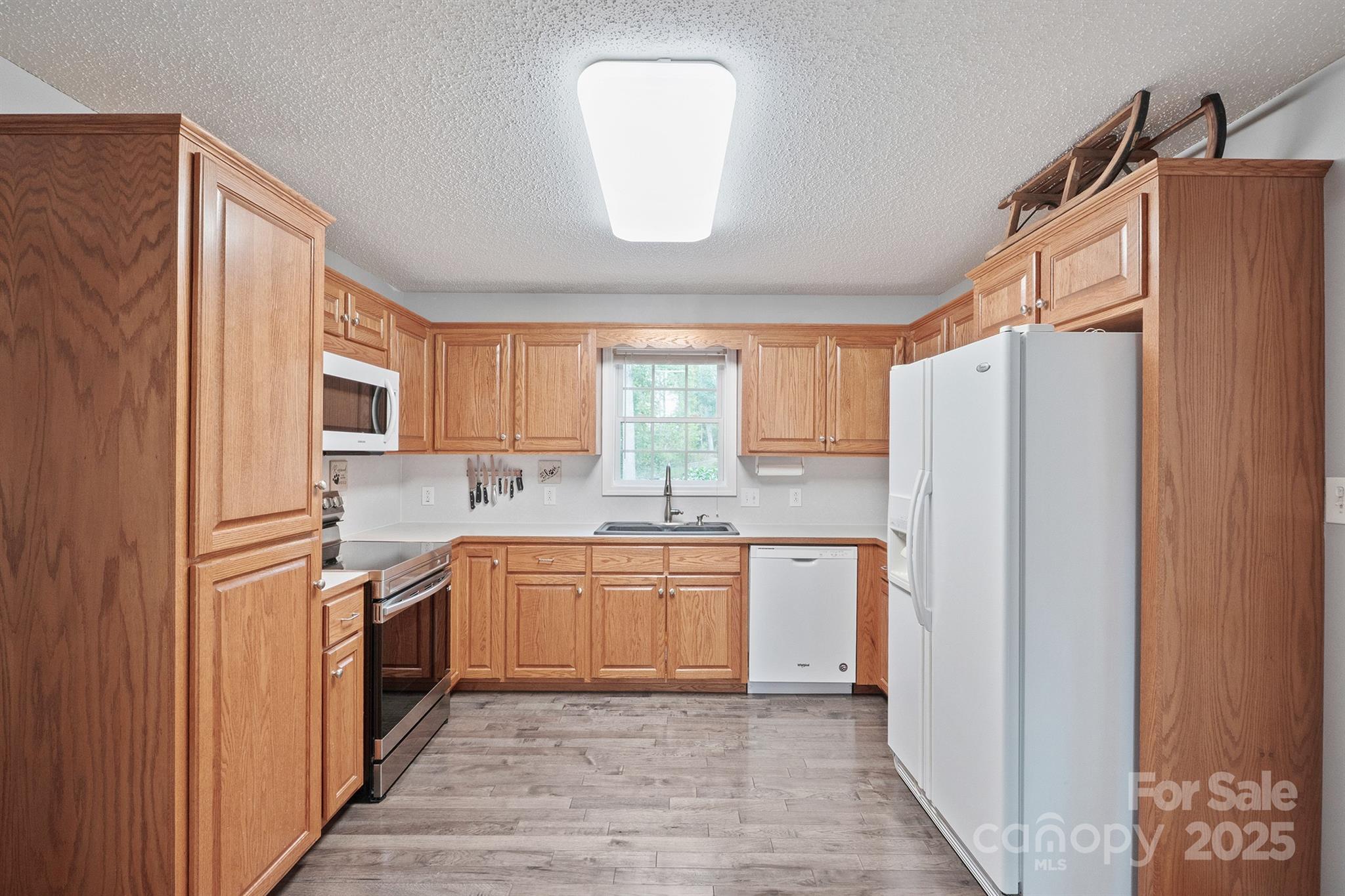 2714 Mauser Drive Newton, NC 28658 - Photo 11 of 38 a kitchen with stainless steel appliances granite countertop a refrigerator and a sink