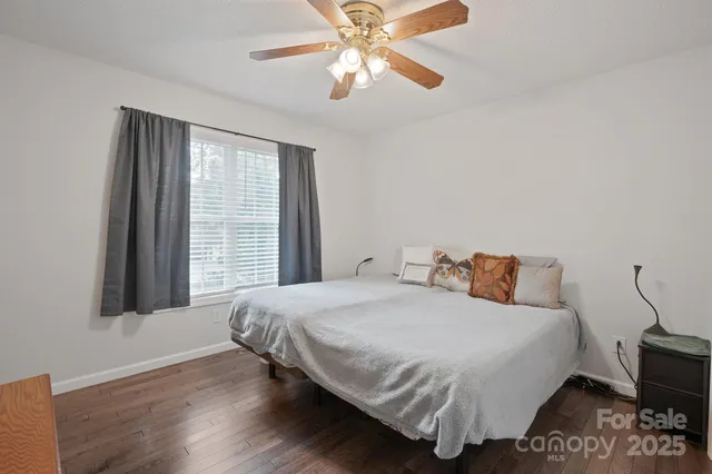 a view of an empty room with a chandelier fan