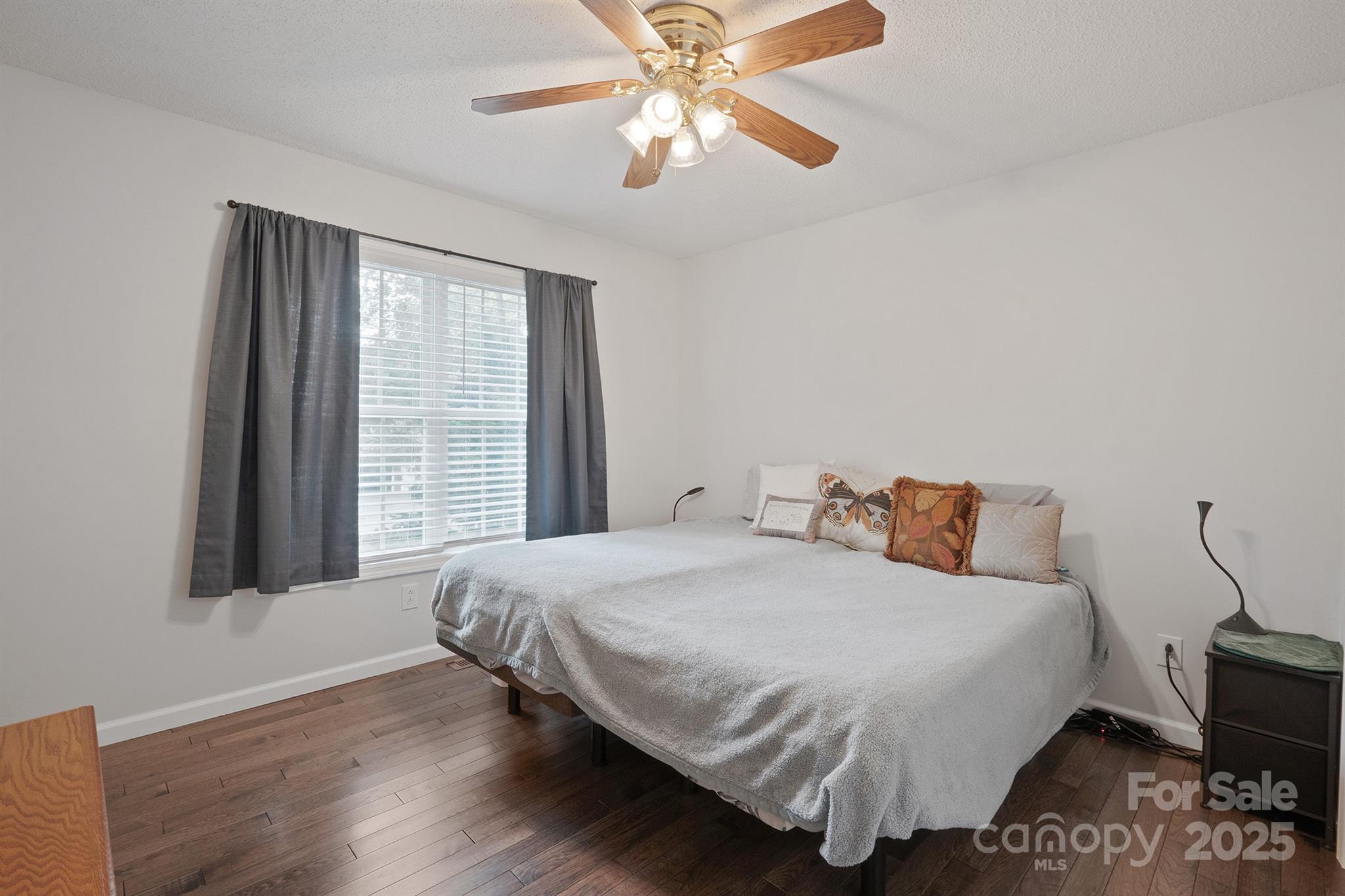 2714 Mauser Drive Newton, NC 28658 - Photo 22 of 38 a bedroom with a bed and a chandelier