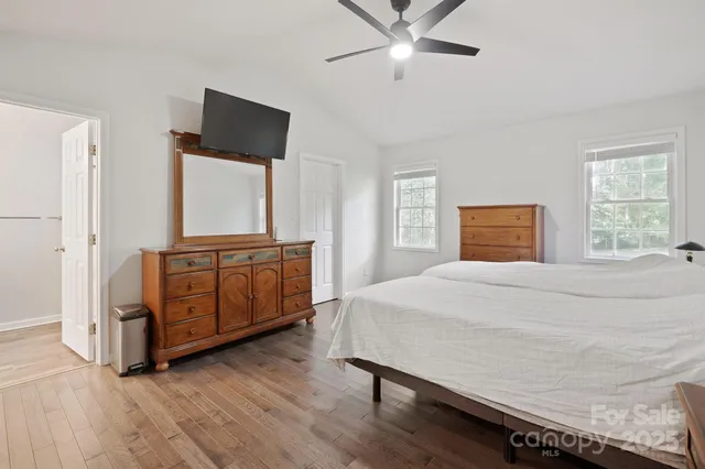 a spacious bedroom with a bed and a window
