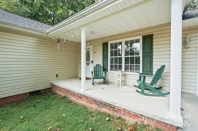 a house view with a sitting space and garden