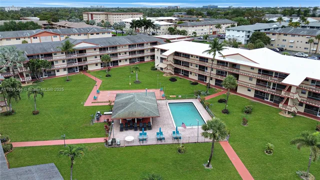 a aerial view of a residential apartment building with a yard