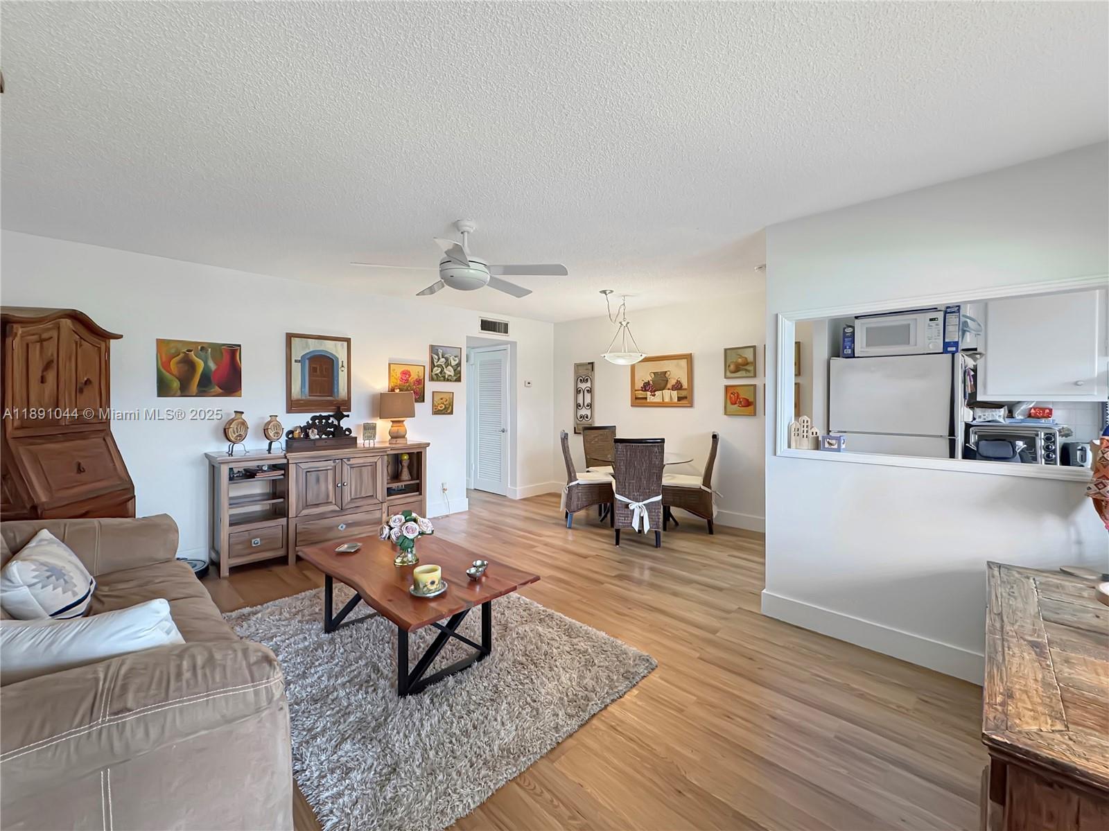 5300 Washington Street, Unit O224 Hollywood, FL 33021 - Photo 3 of 14 a living room with furniture and a wooden floor