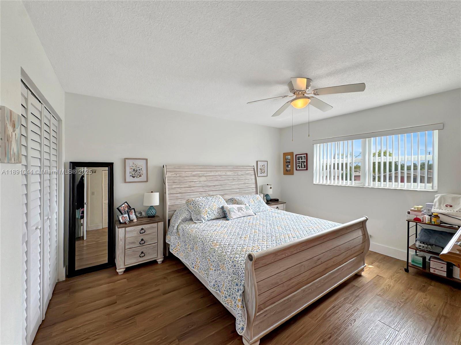 5300 Washington Street, Unit O224 Hollywood, FL 33021 - Photo 7 of 14 a bedroom with a bed and a chandelier