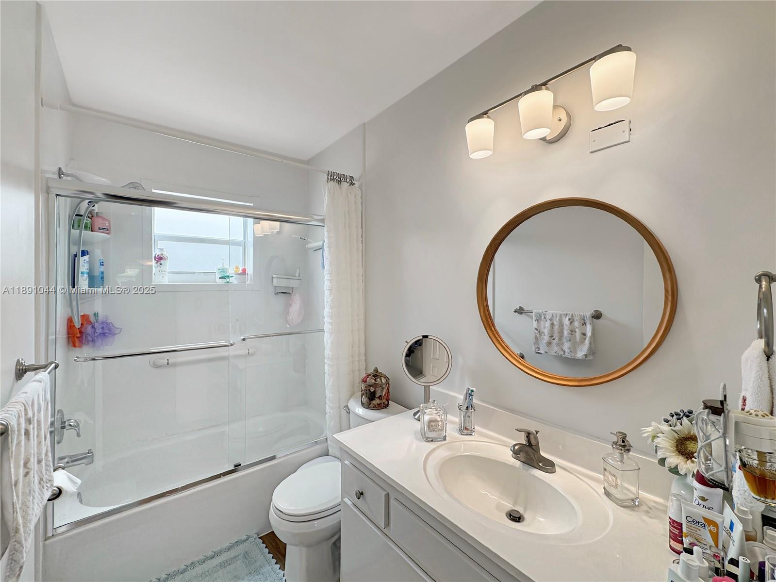 5300 Washington Street, Unit O224 Hollywood, FL 33021 - Photo 9 of 14 a bathroom with a sink a mirror and a toilet