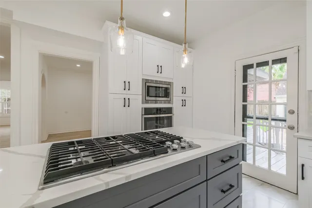a stove top oven sitting next to a window