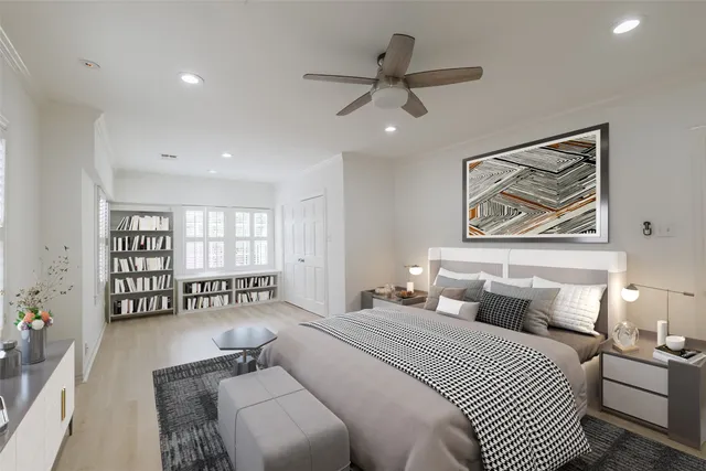 a bedroom with a large bed couch and a window