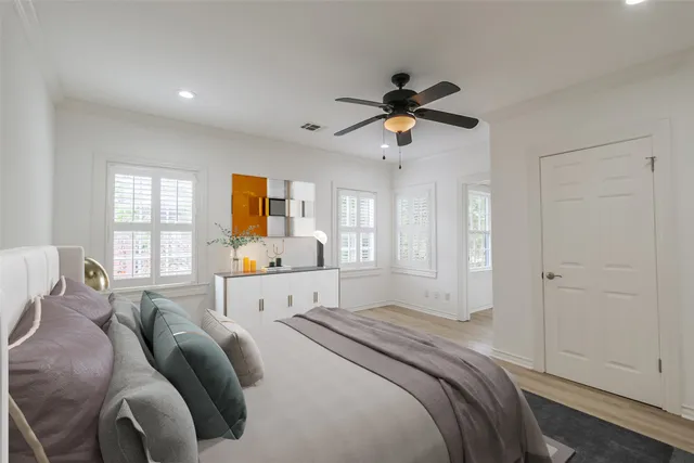 a view of a bedroom with a bed and a window