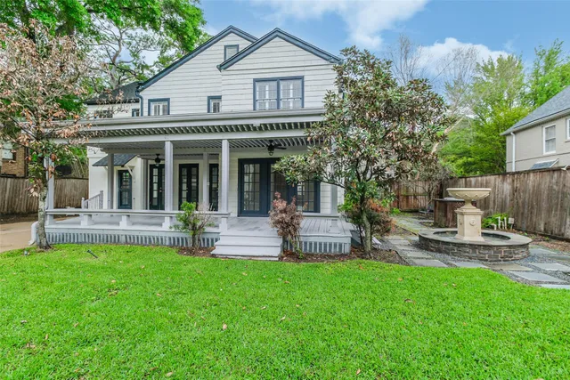 a view of a house with a yard and sitting area