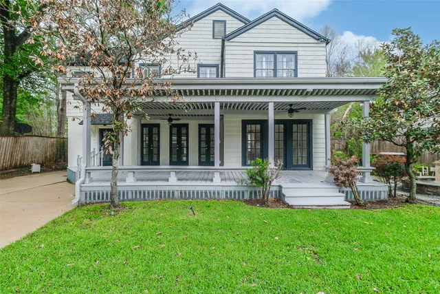 a view of a house with a yard and sitting area