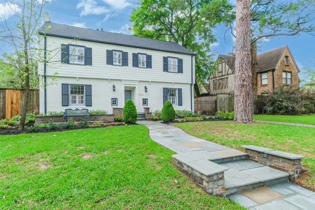 a front view of house with yard and green space