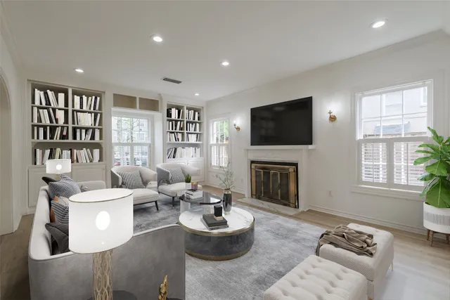 a living room with furniture a fireplace and a flat screen tv