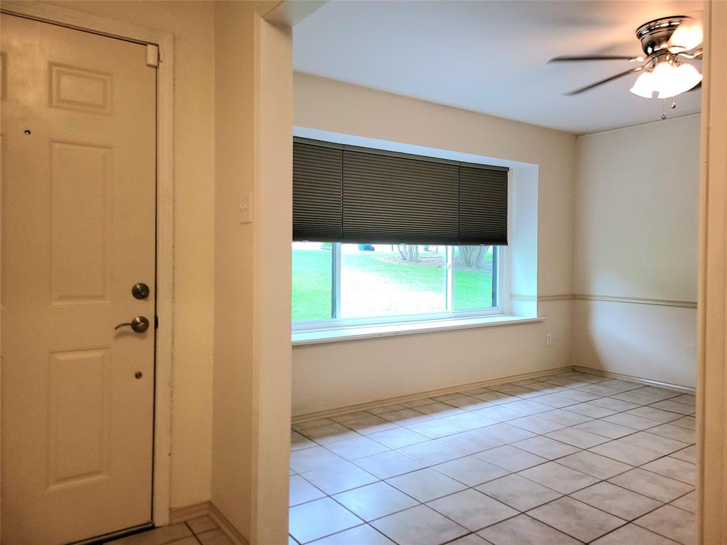 912 North Dove Road Grapevine, TX 76051 - Photo 3 of 36 a view of an empty room with window and a ceiling fan
