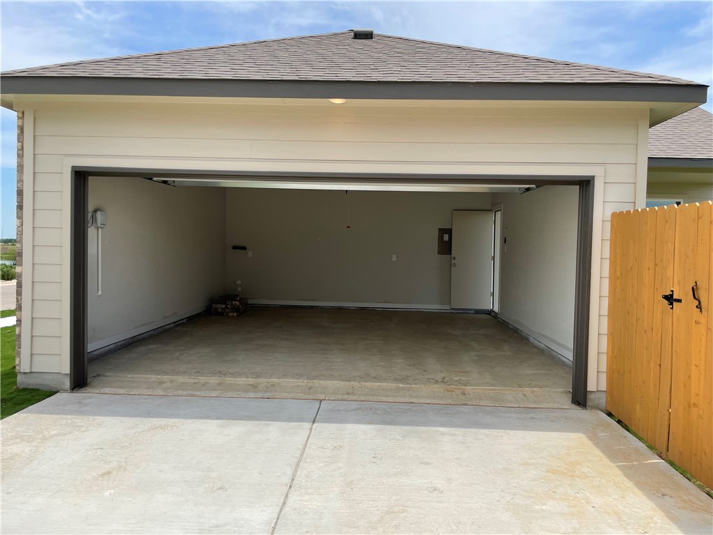 609 Paddock Lane Georgetown, TX 78626 - Photo 30 of 40 A clean concrete driveway leads into a spacious two-car garage with integrated interior access.
