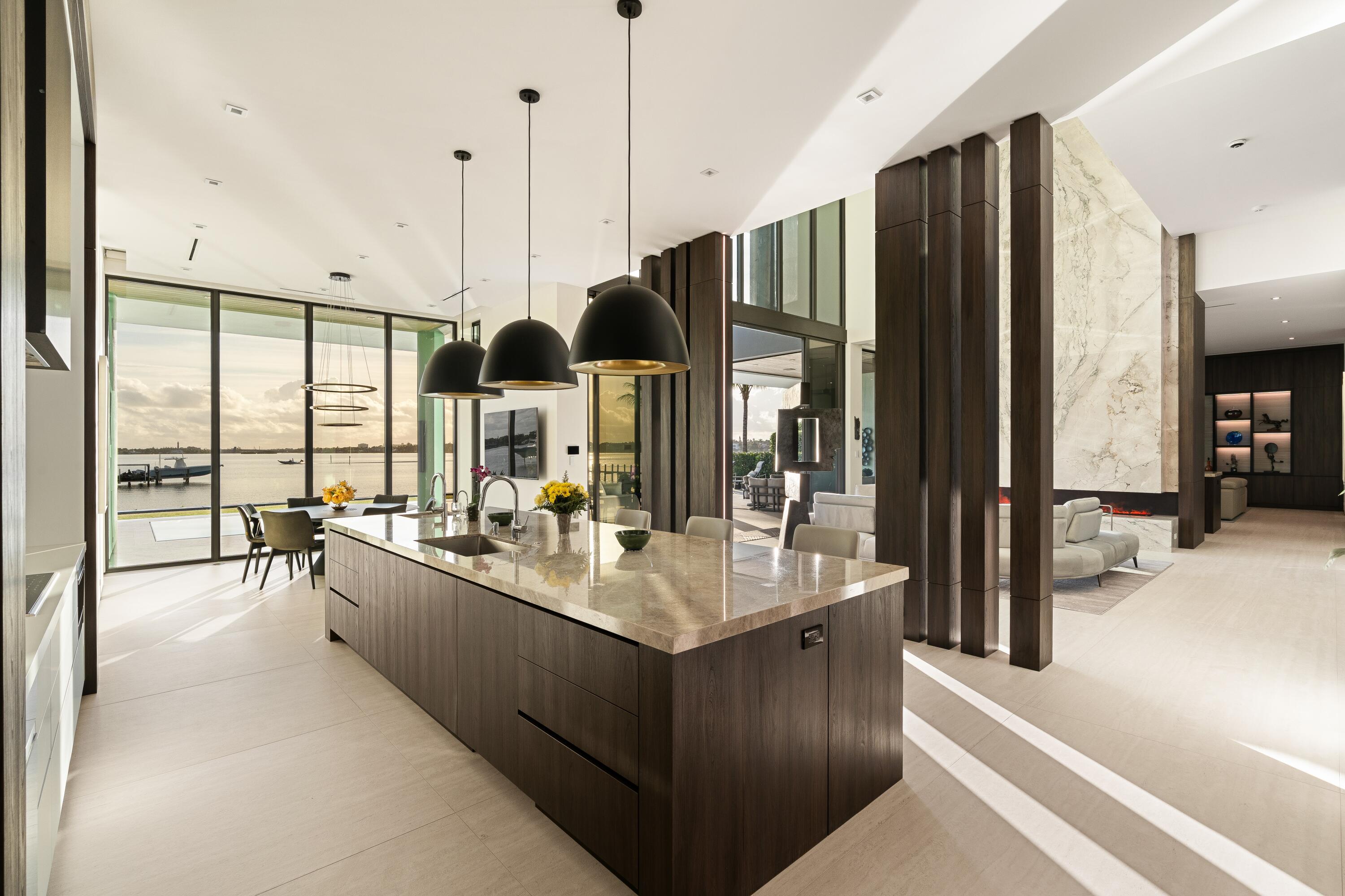 5211 Pennock Point Road Jupiter, FL 33458 - Photo 16 of 69 a large kitchen with kitchen island a large window a sink and stainless steel appliances