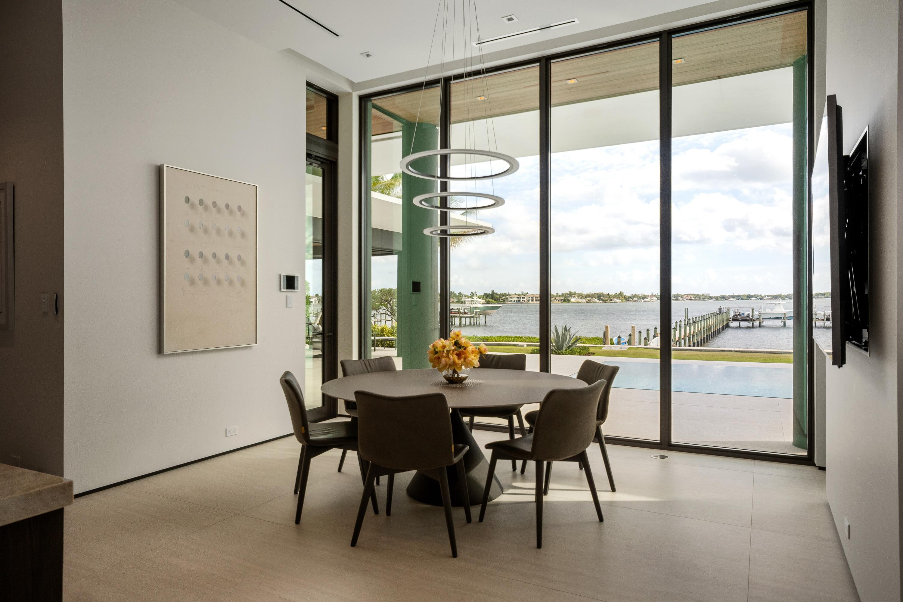 5211 Pennock Point Road Jupiter, FL 33458 - Photo 19 of 69 a dining room with furniture and a floor to ceiling window