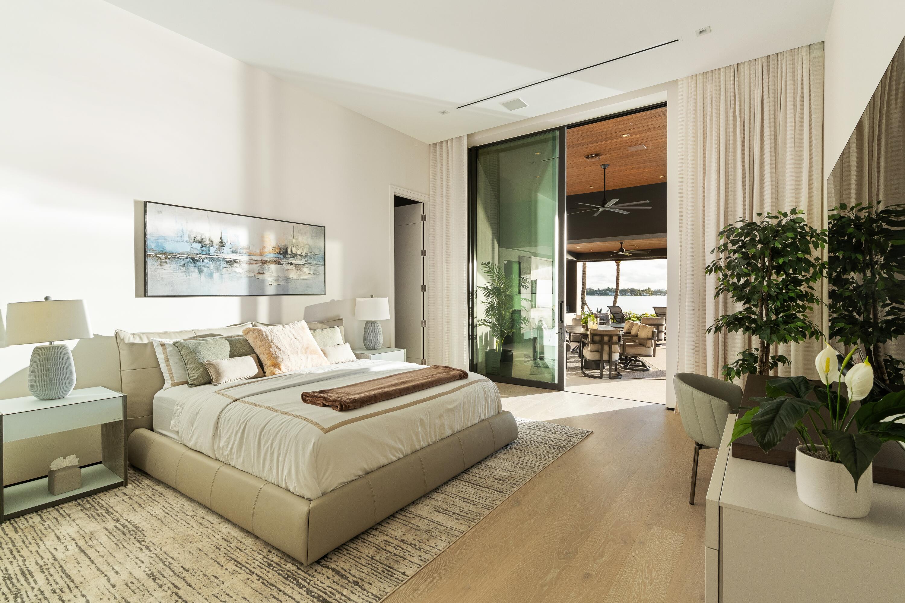 5211 Pennock Point Road Jupiter, FL 33458 - Photo 35 of 69 a bedroom with a large bed and a large window